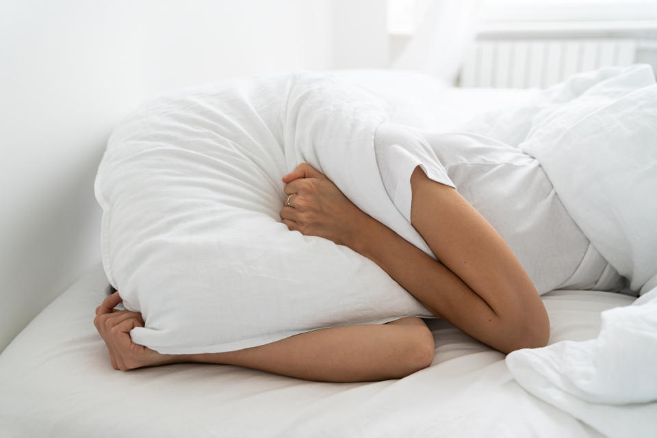 woman blocking ears in bed aldi