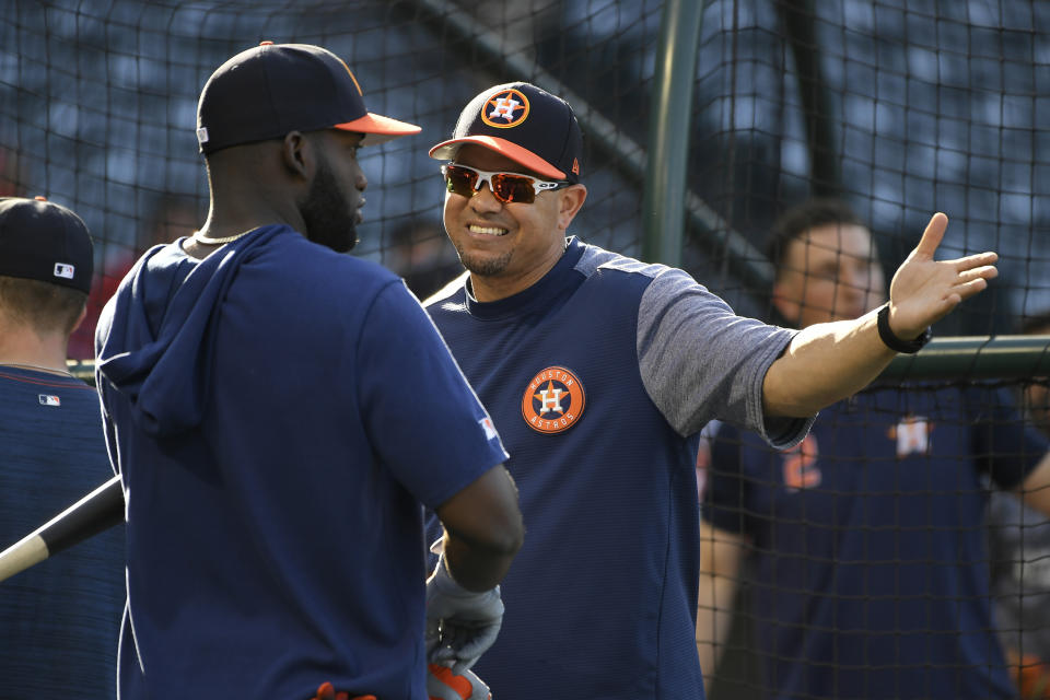 Astros hitting coach Alex Cintron, center, has been in the middle of three controversies. (Photo by John McCoy/Getty Images)