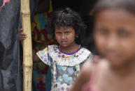 A girl in a makeshift shelter on road at a flood-affected village in Morigaon district of Assam in India, Friday, July 17, 2020. (Photo by David Talukdar/NurPhoto via Getty Images)