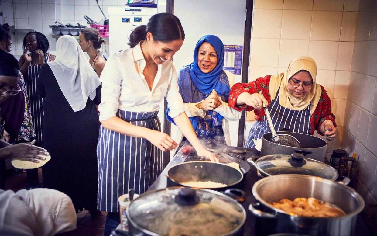 The Duchess of Sussex cooks with women in the Hubb Community Kitchen at the Al Manaar Muslim Cultural Heritage Centre in west London, in the aftermath of the Grenfell Tower fire in 2017 - Jenny Zarins