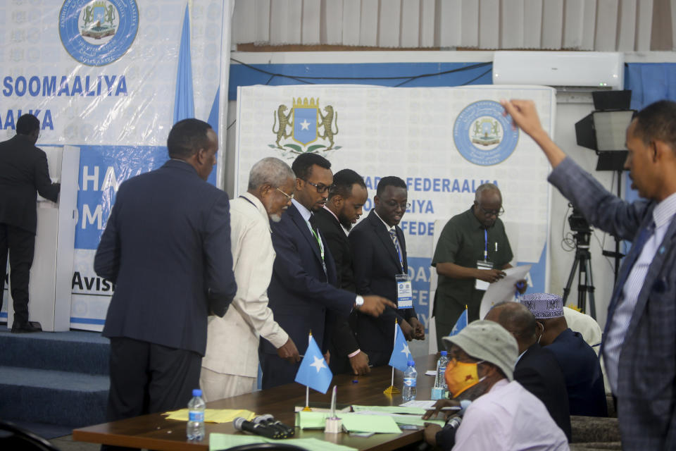 Somali lawmakers cast their votes in the presidential election, at the Halane military camp which is protected by African Union peacekeepers, in Mogadishu, Somalia Sunday, May 15, 2022. Legislators in Somalia are meeting Sunday to elect the country's president in the capital, Mogadishu, which is under lockdown measures aimed at preventing deadly militant attacks. (AP Photo/Farah Abdi Warsameh)