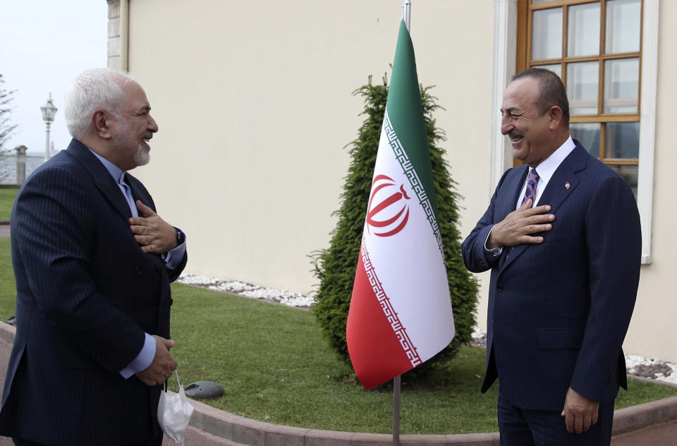 Turkish Foreign Minister Mevlut Cavusoglu, right, and Iran's Foreign Minister Mohammad Javad Zarif, greet each other after a meeting, in Istanbul, Monday, June 15, 2020. The two discussed bilateral issues and Syria. (Turkish Foreign Ministry via AP, Pool)