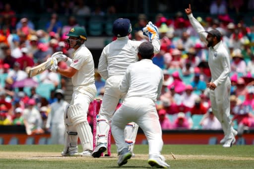 Australia's Marcus Harris (L) reacts after being dismissed by India's Ravindra Jadeja on the third day of their fourth and final Test match, at the Sydney Cricket Ground, on January 5, 2019