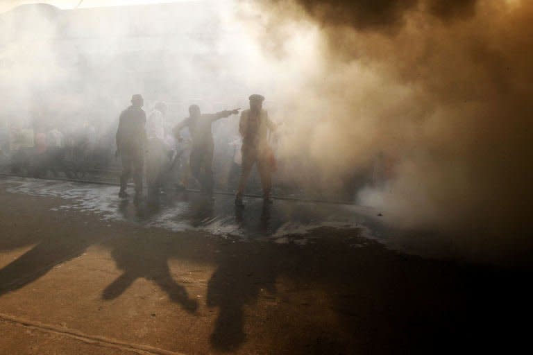 Bangladeshi firefighters attempt to extinguish a burning train compartment at Dhaka's Kamalapur Railway Station during a nationwide strike called by Jamaat-e-Islami on March 4, 2013