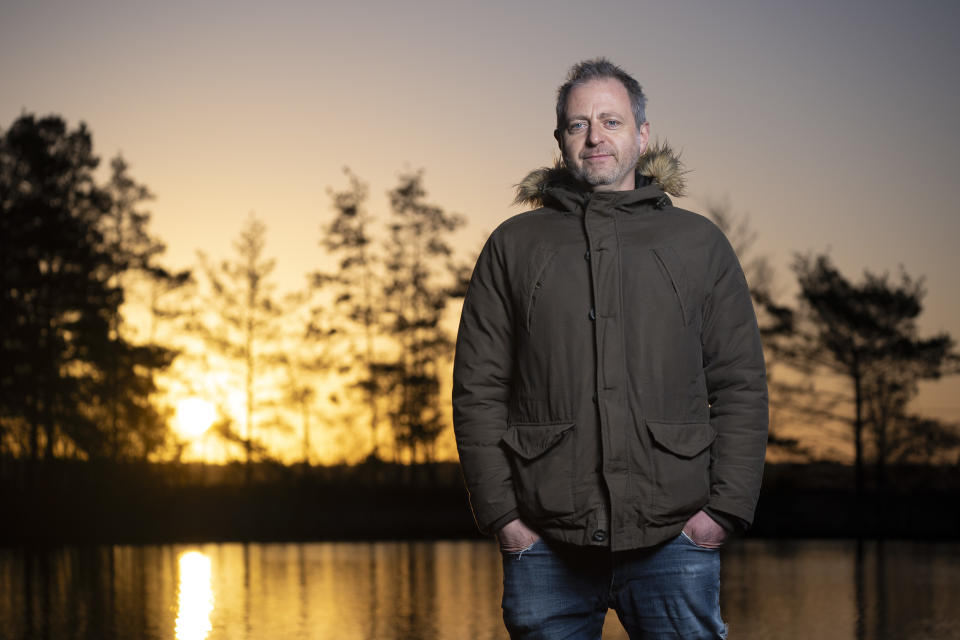 Flash photography portrait taken with the Sony A9 III at first light with golden hour background reflected in a lake