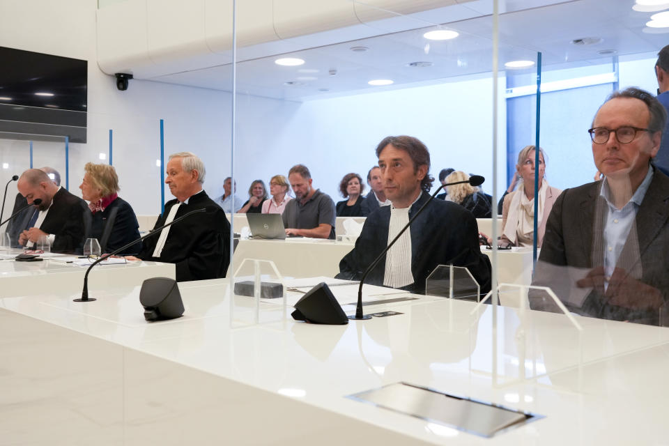 Rob Meijer, third from left, lawyer for the Crimean museums and Paul Loeb, lawyer for the Allard Pierson Museum, center right, wait for the presiding judge to read the verdict in a Dutch appeals court in Amsterdam, Tuesday Oct. 26, 2021, on ownership of a trove of Crimean historical artifacts that were loaned to an Amsterdam museum shortly before Russia annexed the region. A lower court ruled in 2016 that the treasures should be handed to the Ukrainian government. (AP Photo/Peter Dejong)