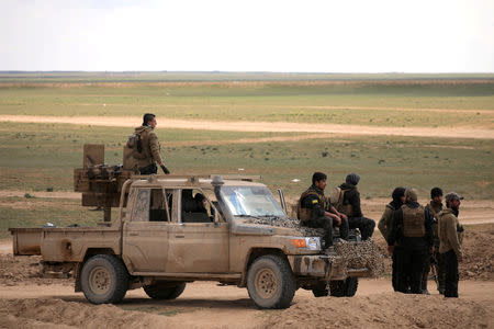 Members of Syrian Democratic Forces (SDF) stand together near Baghouz, Deir Al Zor province, Syria February 11, 2019. REUTERS/Rodi Said