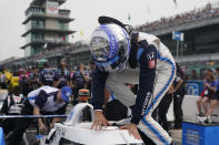 Alex Palou, of Spain, climbs into his car before qualifications for the Indianapolis 500 auto race at Indianapolis Motor Speedway, Saturday, May 21, 2022, in Indianapolis. (AP Photo/Darron Cummings)