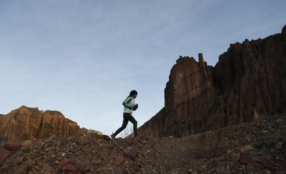 Gracce Kelly Flores, a 12-year-old boxer who goes by the nickname Hands of Stone, runs during her daily boxing workout as she trains under the coaching of her father in Palca, Bolivia, early Thursday, June 10, 2021, amid the COVID-19 pandemic. At age 8, Flores defeated a 10-year-old boy, and with three national boxing medals under her belt, she dreams of reaching the women's boxing world championship. (AP Photo/Juan Karita)