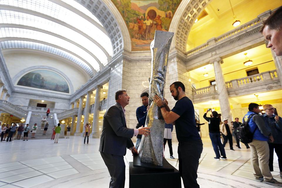 Derrin Hill, left, and David Oakes position a small replica of the Statue of Responsibility in the Capitol rotunda in Salt Lake City on Wednesday, Sept. 7, 2016. | Ravell Call, Deseret News