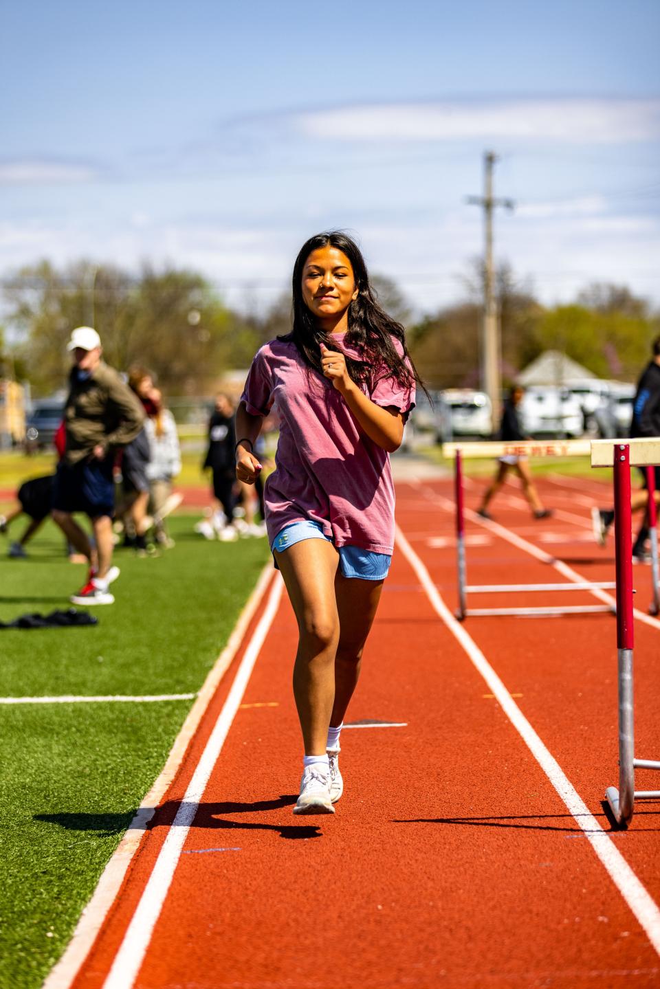 Dewey High junior Tania Salinas warms up around the track. She just barely finished one spot out of qualifying for this year's state meet. She appears to have an excellent shot next year of earning a spot in the Big Show. Salinas also has been one of the state's best cross country runners in 3A/4A.