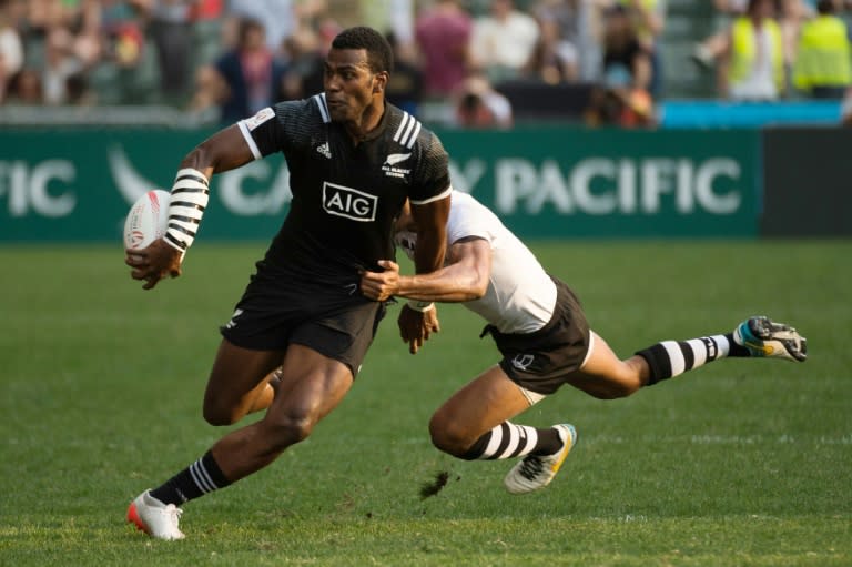 New Zealand's Joe Ravouvou (L) is tackled during their match against Fiji at the Hong Kong Rugby Sevens tournament