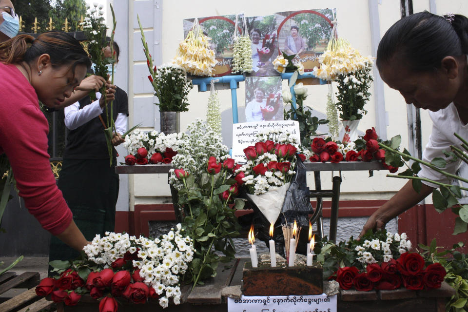 People offer flowers as a tribute to a teacher who died in a protest on Feb 28, during a memorial service in Yangon, Myanmar, Monday, March 1, 2021. (AP Photo)