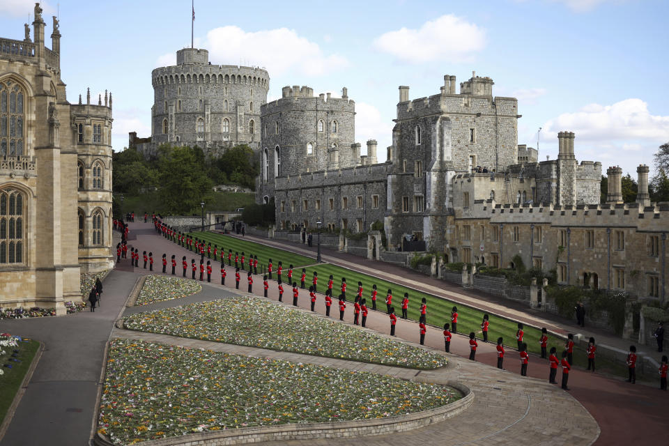 Guards line along the procession route at Windsor Castle, Windsor, England, Monday Sept. 19, 2022, ahead of the committal service for Queen Elizabeth II. The Queen, who died aged 96 on Sept. 8, will be buried at Windsor alongside her late husband, Prince Philip, who died last year. (Henry Nicholls/Pool via AP)