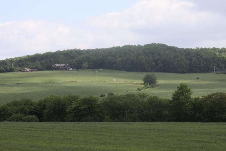 Rolling hills dotted with homes and farms surround Farmersville.  