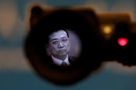 Chinese Premier Li Keqiang is seen on a camera viewfinder at the news conference following the closing session of the National People's Congress (NPC), at the Great Hall of the People in Beijing, China March 20, 2018. REUTERS/Jason Lee