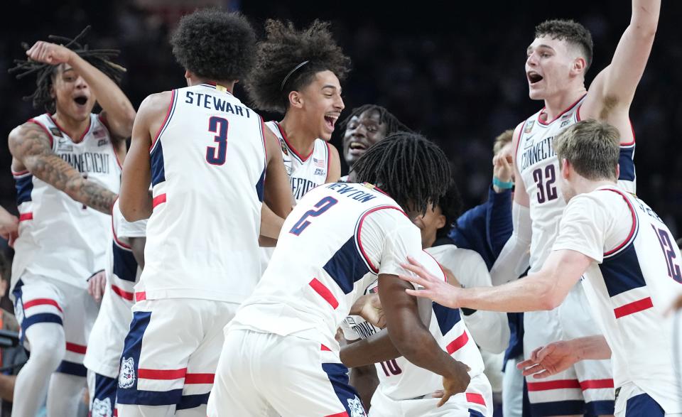 Connecticut players celebrate after defeating Purdue in the national championship game of the 2024 NCAA men's tournament, Saturday, April 8, 2024, at State Farm Stadium in Glendale, Ariz.