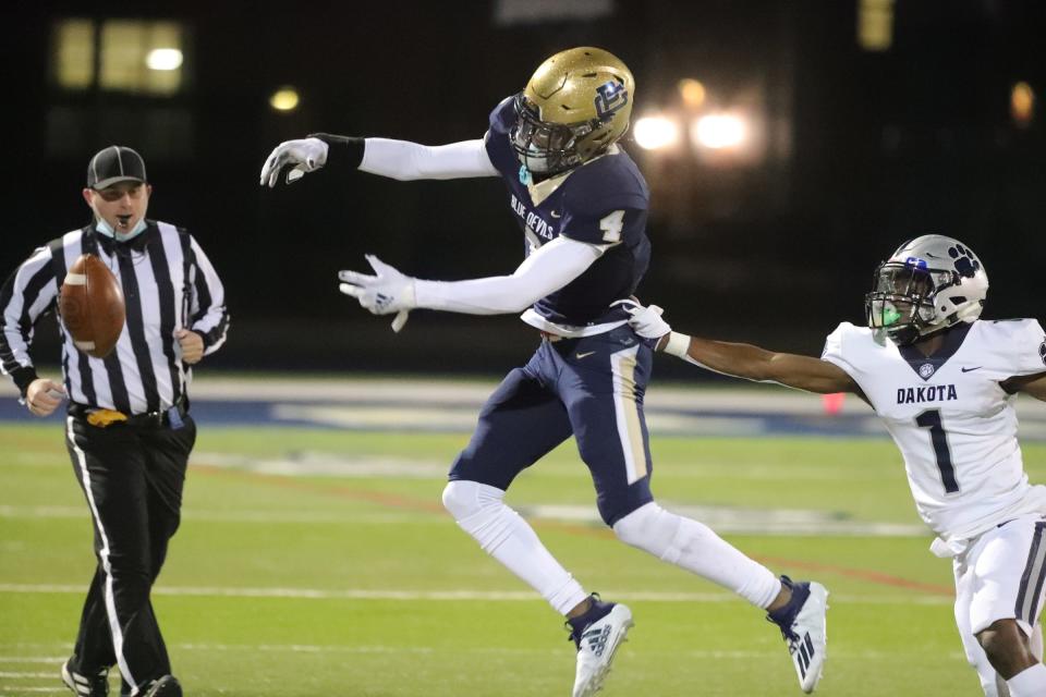 Grosse Pointe South receiver Will Johnson is defended by Macomb Dakota's Eric Reese at Grosse Pointe South high school Friday, Oct. 2, 2020.