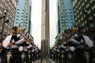 Firefighter bagpipers attend a ceremony at the 9/11 memorial during the 13th anniversary of the 9/11 attacks on the World Trade Center, in Exchange Place, New Jersey, September 11, 2014.REUTERS/Eduardo Munoz