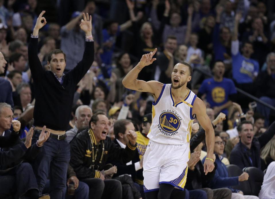 Golden State Warriors' Stephen Curry celebrates a score against the Cleveland Cavaliers during the first half of an NBA basketball game, Monday, Jan. 16, 2017, in Oakland, Calif. (AP Photo/Ben Margot)