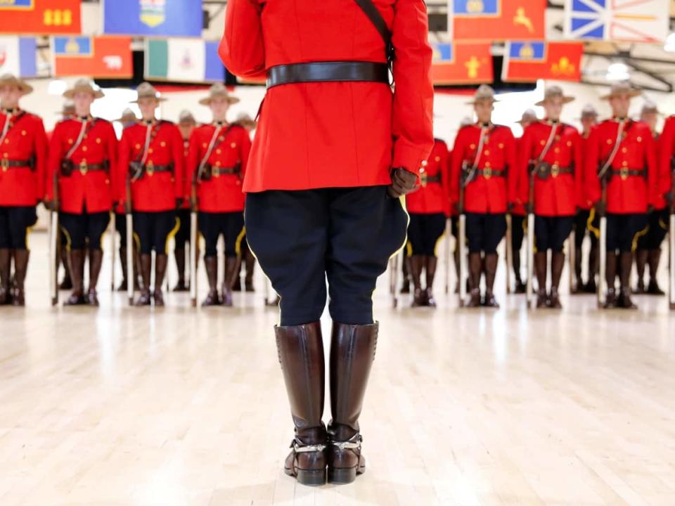 Royal Canadian Mounted Police cadets await badge presentations at a graduation ceremony at the RCMP Academy in Regina on June 5, 2017. (Valerie Zink/Reuters - image credit)