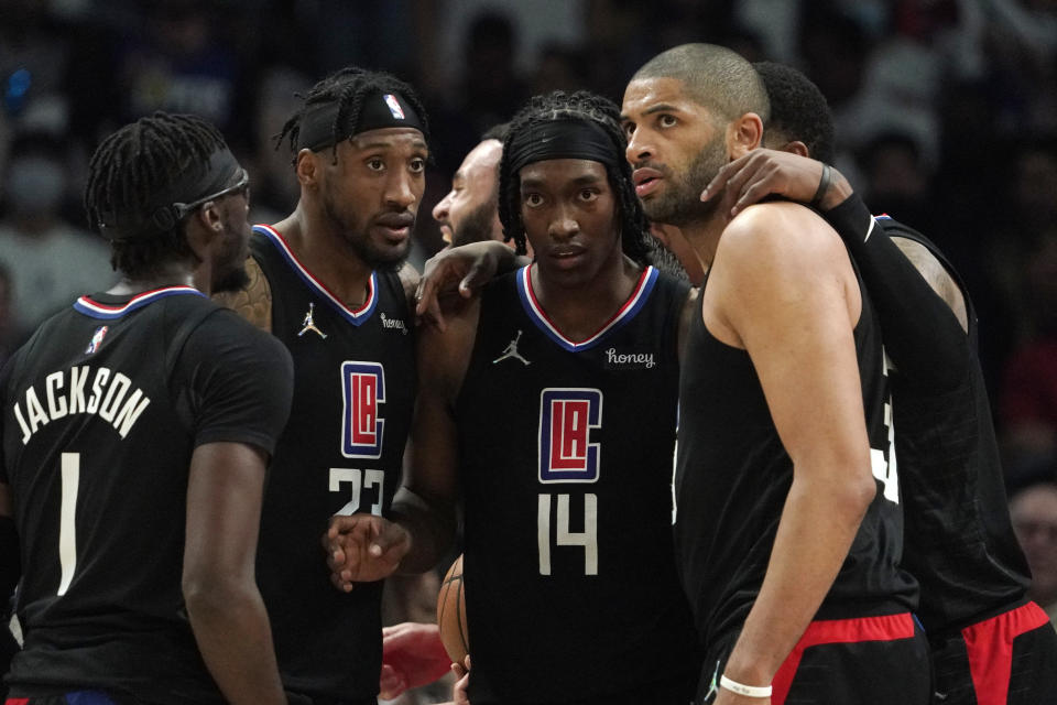 Members of the Los Angeles Clippers, from left, Reggie Jackson, Robert Covington, Terance Mann, Nicolas Batum and Marcus Morris Sr. huddle during the second half of an NBA basketball play-in tournament game against the New Orleans Pelicans Friday, April 15, 2022, in Los Angeles. The Pelicans won 105-101. (AP Photo/Mark J. Terrill)