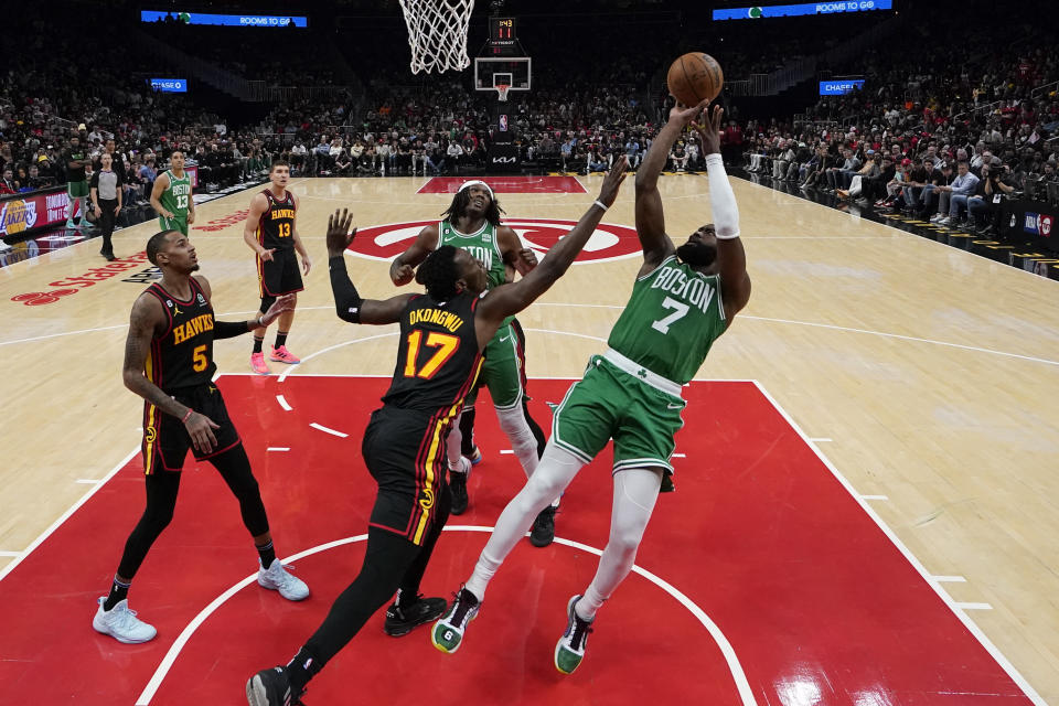 Boston Celtics guard Jaylen Brown (7) shoots and scores against Atlanta Hawks forward Onyeka Okongwu (17) during the second half of Game 4 of a first-round NBA basketball playoff series, Sunday, April 23, 2023, in Atlanta. (AP Photo/Brynn Anderson)