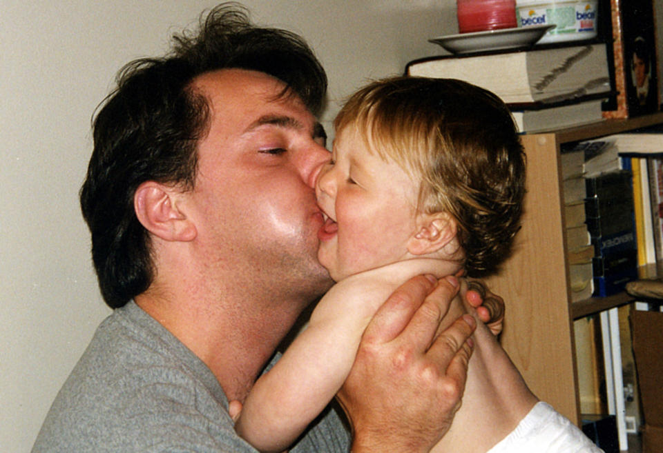 A man kissing a baby