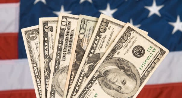 American currency against an American flag backdrop