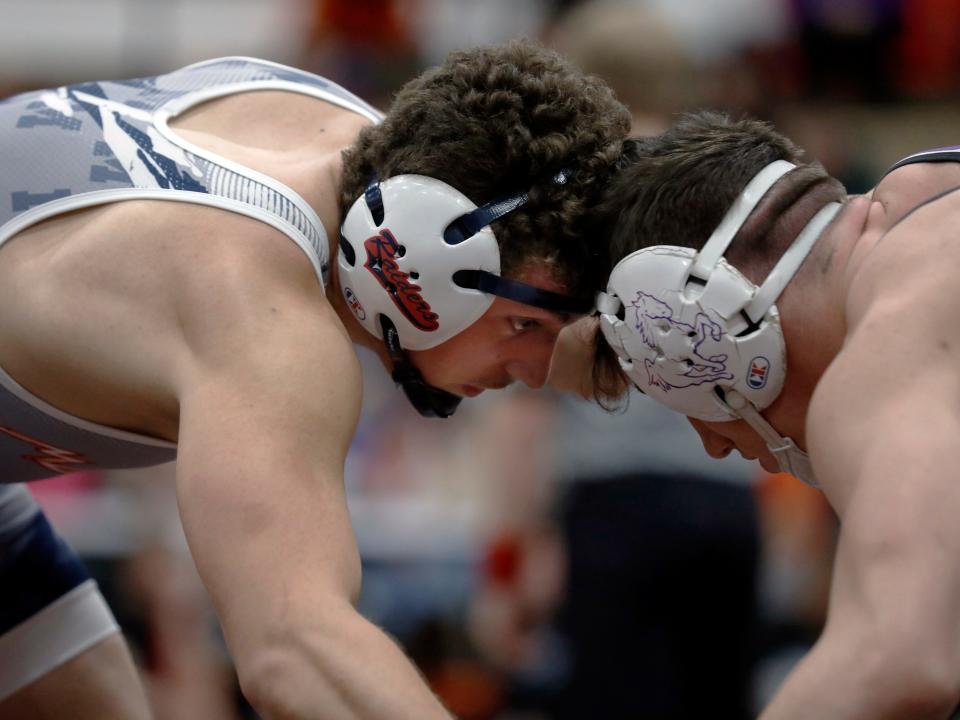 Morgan senior Logan Niceswanger, left, and Columbus DeSales' Lincoln Shulaw wrestle in the championship match at 190 pounds during the Jimmy Wood Invitational on Jan. 27, 2024, at New Lexington High School.