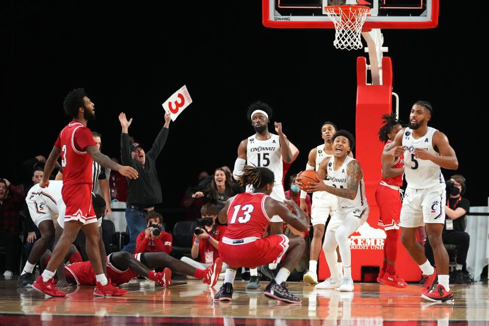 Cincinnati Bearcats guard Jeremiah Davenport (24), center, and the team reacts at the conclusion of the second half of an NCAA men's college basketball game against the Miami (Oh) Redhawks, Wednesday, Dec. 1, 2021, at Millett Hall in Oxford, Ohio. The Cincinnati Bearcats won, 59-58.