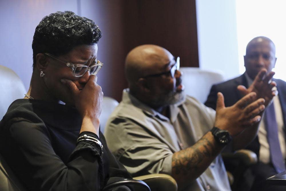 Veldarin Jackson, Sr., center, talks about receiving the call that his mother, Janice Reed, had died as his wife Adjoa Jackson, left, becomes emotional, Tuesday, May 24, 2022, in Chicago. (Jose M. Osorio/Chicago Tribune via AP)