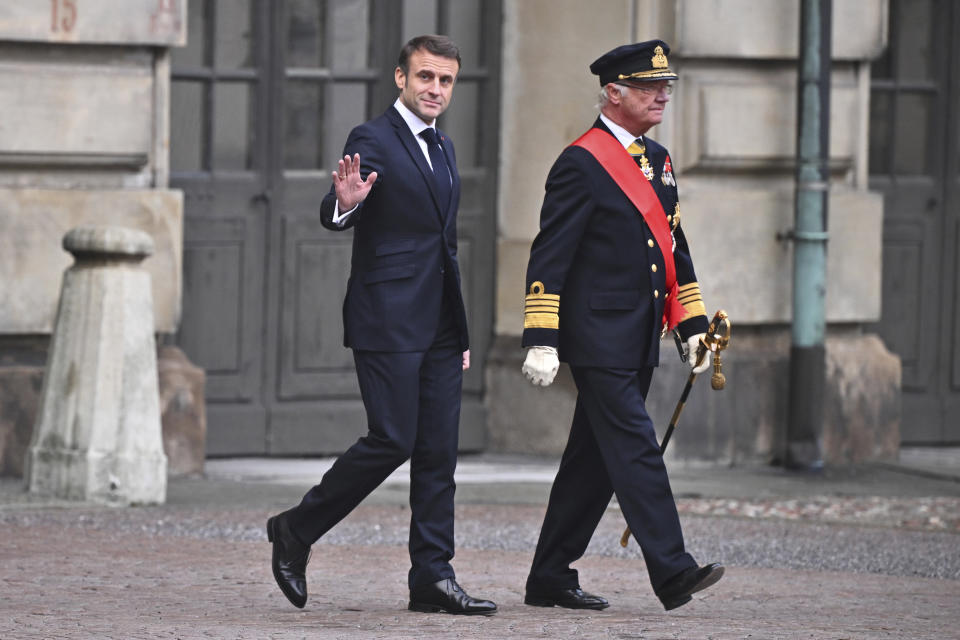 French President Emmanuel Macron, left, and Sweden's King Carl XVI Gustaf inspect the Grenadier Guards of the Life Guards during a welcome ceremony at the Inner Courtyard of the Royal Palace in Stockholm, Sweden, Tuesday Jan. 30, 2024. France’s President Emmanuel Macron started a two-day state visit in Stockholm during which he will meet Swedish prime minister, Ulf Kristersson, and the country’s monarch, King Carl XVI Gustaf. (Claudio Bresciani/TT via AP)