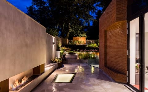 Three sections of walk-on structural glazing in this Hampstead garden let the daylight in  - Credit: Will Scott