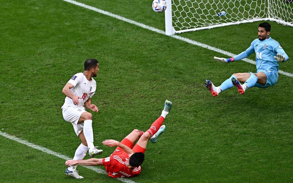 Hossein Hosseini saves a shot by Wales' forward #13 Kieffer Moore during the Qatar 2022 World Cup Group B football match between Wales and Iran at the Ahmad Bin Ali Stadium - AFP