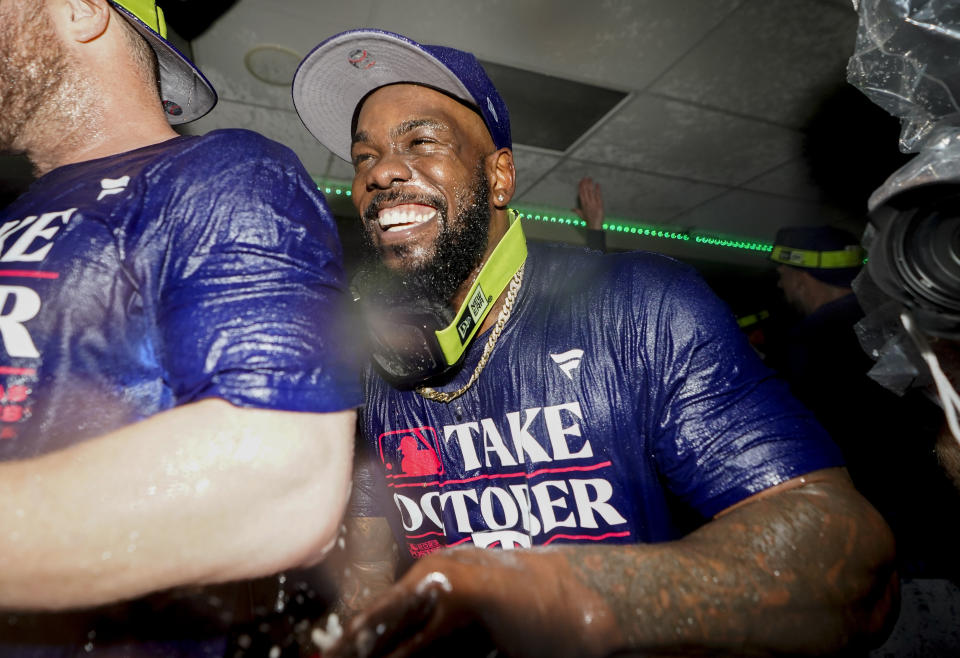 FILE - Texas Rangers right fielder Adolis García celebrates with teammates after they clinched a playoff spot in the American League after a 6-1 win over the Seattle Mariners in a baseball game Sept. 30, 2023, in Seattle. The World Series champion Rangers finalized deals Friday, Jan. 26, 2024, with veteran reliever David Robertson and outfielder Travis Jankowski, but still have no agreement with AL Championship Series MVP García in advance of salary arbitration hearings. (AP Photo/Lindsey Wasson, File)