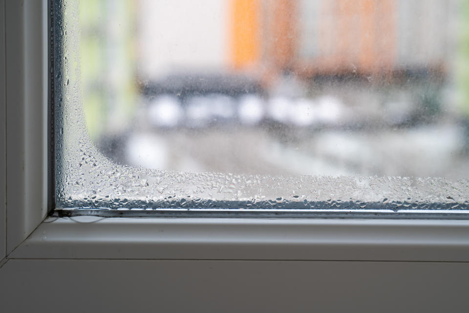 Condensation on a window with blurry view of street outside