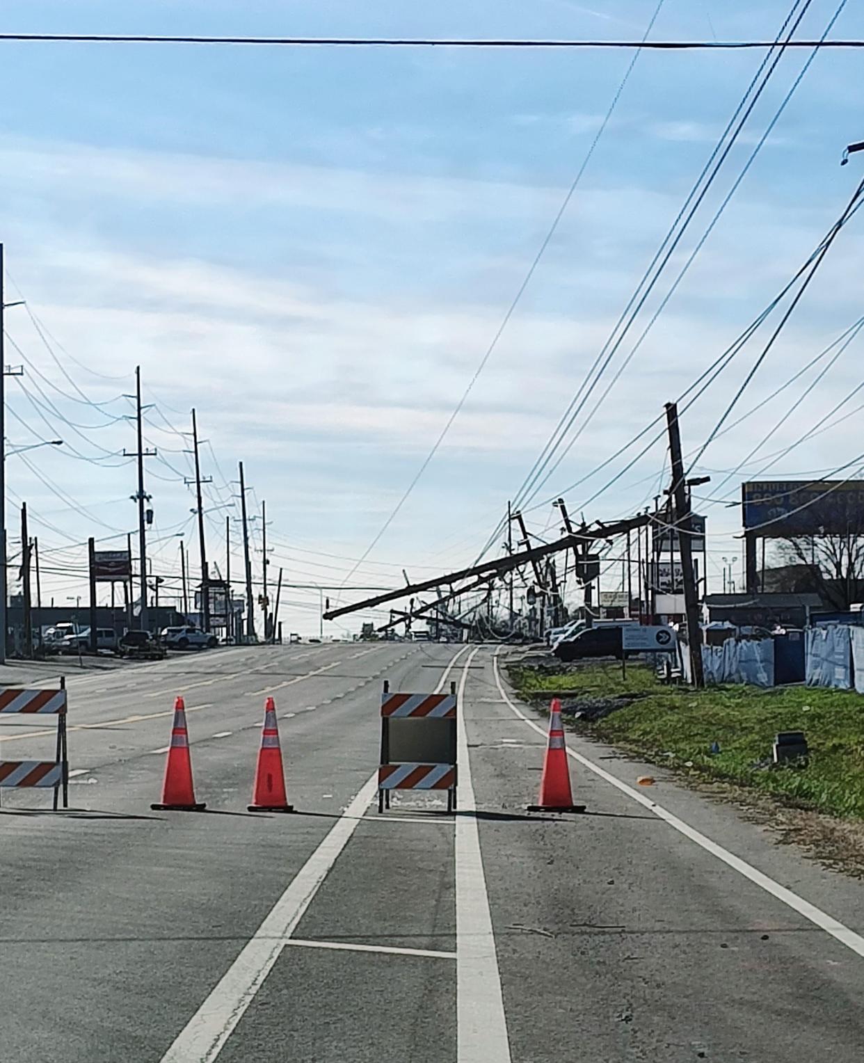 Cleaved power poles hang over Gallatin Pike in Madison following Saturday's devastating tornadoes.