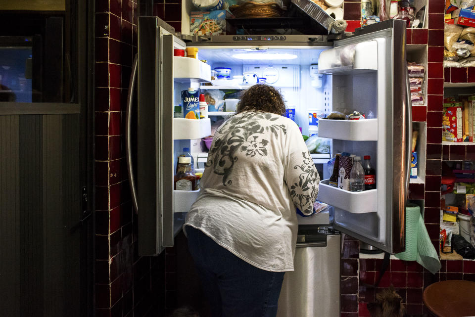 <p>Antonia Casilla Guzman, 62, looks for food in her fridge to prepare a snack. Guzman suffers from obesity, and one of her daughters has had a gastric bypass operation to lose weight. Malnutrition and obesity are two sides of the same coin: While undernutrition undermines physical growth and impairs brain development, obesity can lead to non-communicable diseases such as type II diabetes, hypertension, and cancer. Experts expect that “overnutrition” is expected to become the largest social and economic burden in the region. From 2014 to 2078, overweight and obesity are projected to cost on average $13 billion in Mexico per year. (Photograph by Silvia Landi) </p>