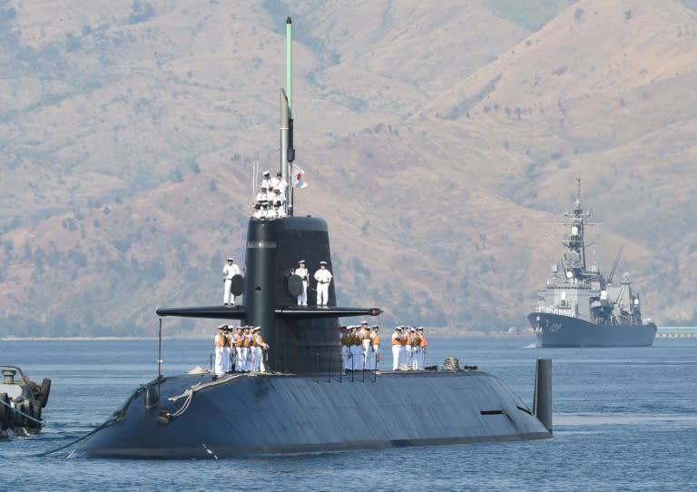 Japanese submarine Oyashio, escorted by one of destroyers JS Ariake (R), arrive at the former US naval base in Subic bay, on April 3, 2016