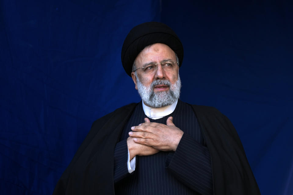 Iranian President Ebrahim Raisi places his hands on his heart as a gesture of respect to the crowd during the funeral ceremony of the victims of Wednesday's bomb explosion in the city of Kerman about 510 miles (820 kms) southeast of the capital Tehran, Iran, Friday, Jan. 5, 2024. Iran on Friday mourned those slain in an Islamic State group-claimed suicide bombing targeting a commemoration for a general slain in a U.S. drone strike in 2020, as the death toll in the attack rose to at least 89. (AP Photo/Vahid Salemi)