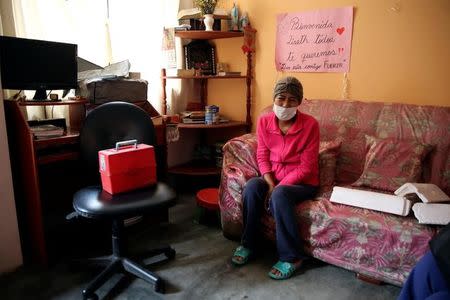 Liseth, 40, sits in her home next to a sign which reads 'Welcome Liseth, we all love you, God is with you, be strong'. She was diagnosed with tuberculosis six months ago whilst being treated for leukemia. Carabayllo in Lima, Peru September 22, 2016. REUTERS/Mariana Bazo