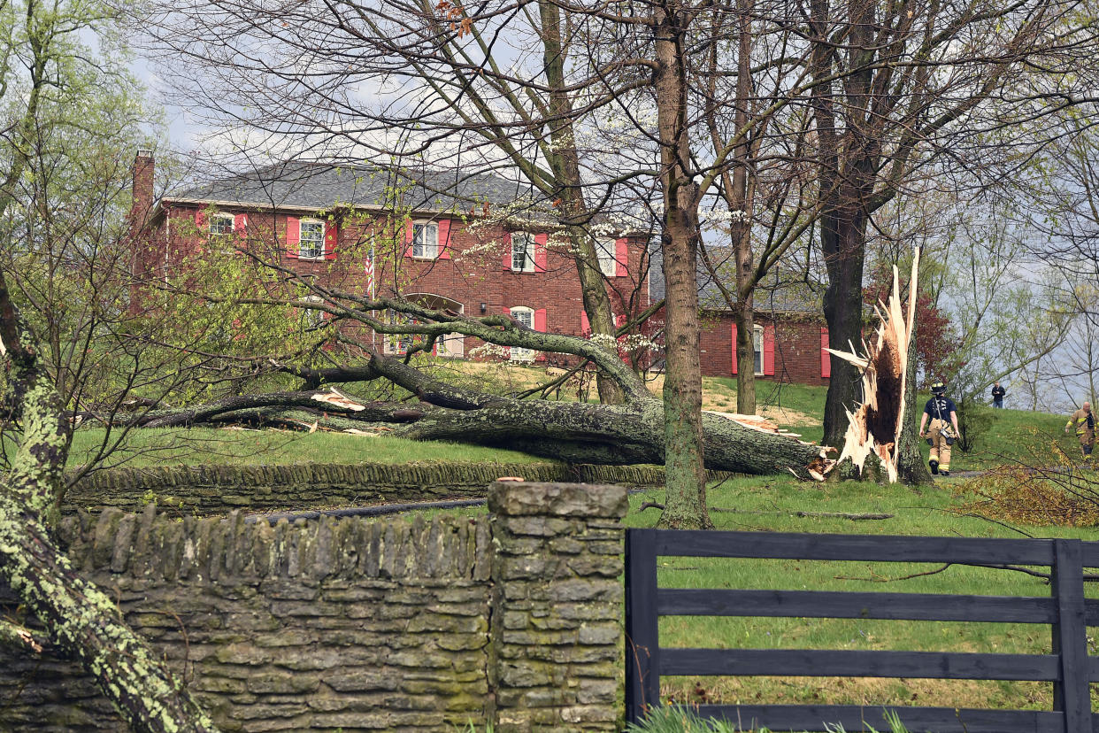 Firefighters, right, with the Anchorage Middletown Fire Department, check houses for gas leaks following severe storms that passed through Prospect, Kentucky, Tuesday, April 2, 2024. / Credit: Timothy D. Easley / AP