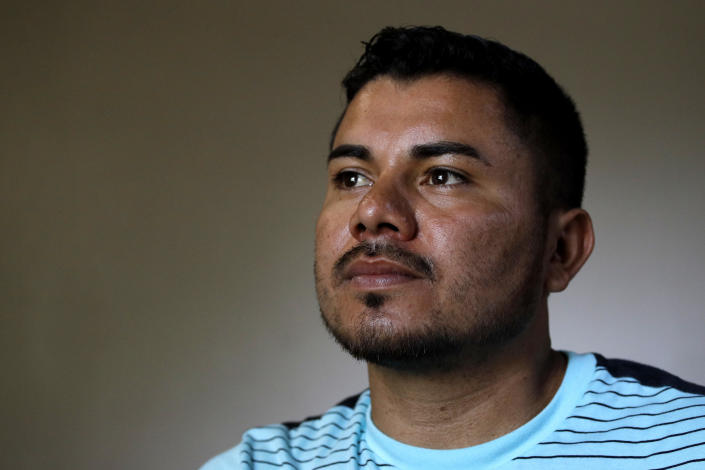 In this photo taken Tuesday, Aug. 28, 2018, Louis Alberto Enamorado Gomez stands in the living room of his home in Grandview, Mo. Living in the U.S. since 2005, Gomez is fighting a deportation order stemming from a 2012 DUI charge because he fears what his removal would mean for his seven children, all U.S. citizens for whom he is the sole provider. (AP Photo/Charlie Riedel)