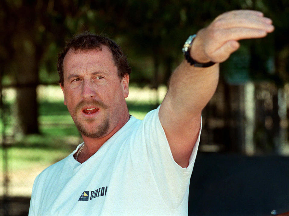 FILE - In this April 26, 1997, file photo, George Holliday points to the spot along a roadside in the Lake View Terrace section of Los Angeles where he videotaped Rodney King being beaten in April 1992, during a news conference in Los Angeles. Holliday, a plumber who gained local and national fame 30 years earlier when he used his video camera to tape the infamous Los Angeles police beating of motorist Rodney King in Lake View Terrace, has died from COVID-19, it was reported Monday, Sept. 20, 2021. (AP Photo/E.J. Flynn, File)