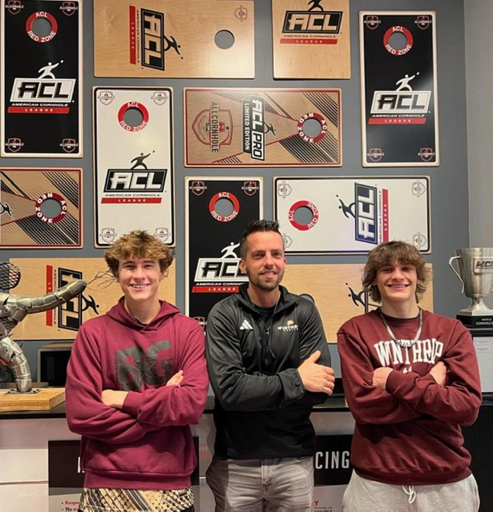 Winthrop cornhole coach Dusty Thompson, center, stands with team signees Gavin Hamann and Jaxson Remmick. They are the first two players to sign with Winthrop’s new cornhole team.