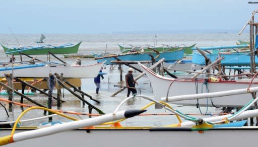 Wooden fishing boats are placed on stilts as fishermen temporarily stop work after a 7.6 magnitude earthquake