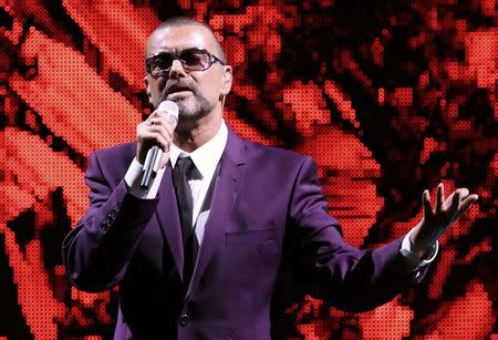 FILE PHOTO - British singer George Michael performs on stage during his "Symphonica" tour concert in Vienna September 4, 2012. REUTERS/Heinz-Peter Bader/File Photo