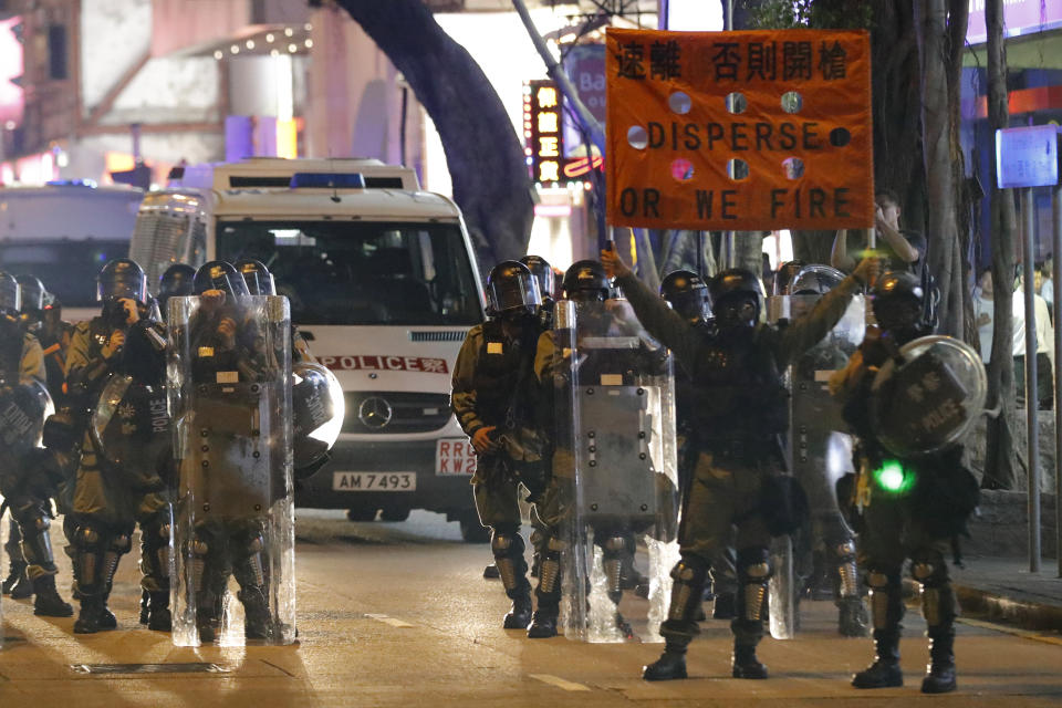 Police prepare to disperse protesters near the Tsim Sha Tsui police station in Hong Kong on Saturday, Aug. 10, 2019. Hong Kong is in its ninth week of demonstrations that began in response to a proposed extradition law but have expanded to include other grievances and demands for more democratic freedoms. (AP Photo/Vincent Thian)