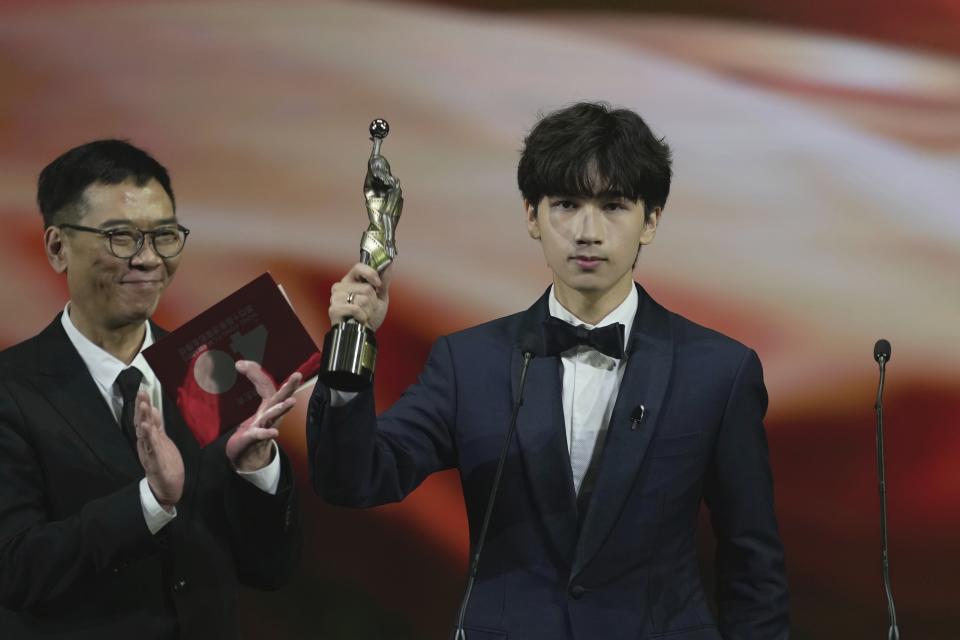 Hong Kong actor Fung Ho-yeung, celebrates after winning the Best supporting Actor award for the movie "Zero To Hero" at the Hong Kong Film Awards, Sunday, July 17, 2022. (AP Photo/Kin Cheung)